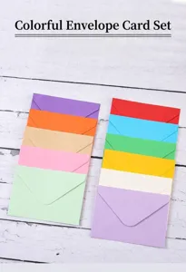 Macro view of assorted colorful European style envelopes on white wood background