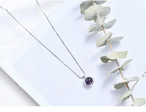 Minimalist silver chain necklace featuring a round purple strawberry quartz pendant detail.