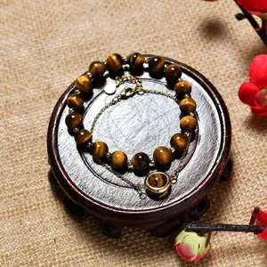 Double-layer tiger's eye bead bracelet with gold chain and circular pendant