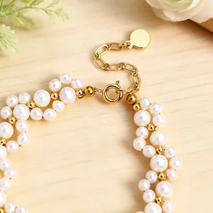 Detailed macro view of high-luster pearl bracelet with 14K gold-plated clasp