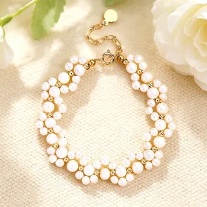 Macro shot of an elegant pearl bracelet featuring 14K gold-filled accents and cat-paw design
