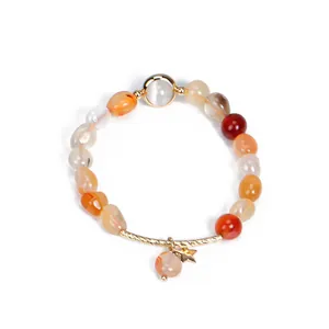 Handmade carnelian and strawberry crystal beaded bracelet with a gold star charm