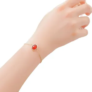 Elegant gold chain bracelet with a round red strawberry crystal gemstone for women