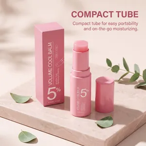 Detailed shot of pink hydrating balm stick and box on a marble surface with leaves