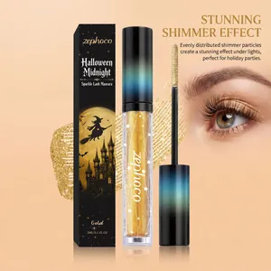 Close-up of gold shimmer mascara tube, applicator wand and sparkling eye makeup detail.