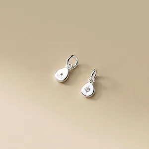 Close-up of 925 sterling silver teardrop charms with star engraving and S925 stamp
