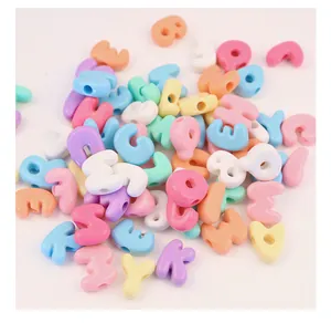 Close-up macro view of pastel macaron colored acrylic letter beads for DIY jewelry