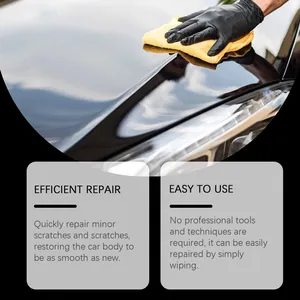 Close-up of car scratch repair cream polishing a black vehicle hood with a cloth