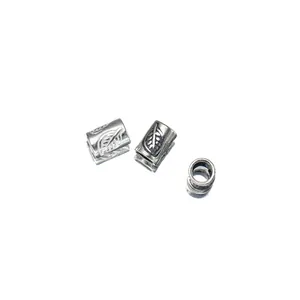 Macro detail of antique silver leaf pattern tube beads for jewelry making