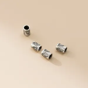 Macro view of 925 sterling silver vintage leaf pattern tube beads for jewelry making.