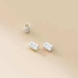 Detailed view of 925 sterling silver tube beads with leaf engraving for jewelry making