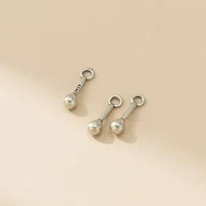 Close-up of three vintage S925 silver matchstick pendants for DIY jewelry making