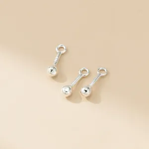 Close-up of vintage 925 sterling silver matchstick charms for DIY jewelry making
