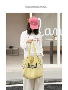 Casual yellow striped canvas tote bag with Bread text print in street style setting