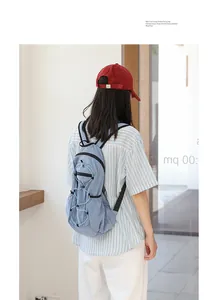 Lifestyle detail shot of a light blue grid nylon backpack with stylish drawstring.