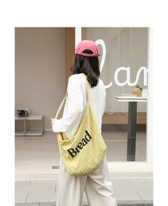 Casual yellow striped canvas tote bag with 'Bread' text print on female model