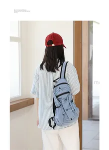 Casual blue checkered nylon backpack shown on model in a bright indoor setting