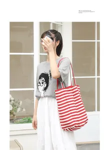 Artsy red and white striped canvas tote bag styled with a casual outfit and coffee cup