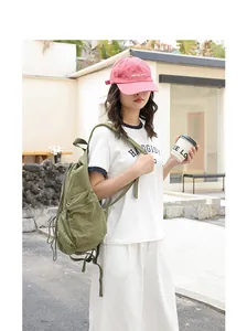 Olive green checkered nylon backpack with drawstring pleated design in outdoor street setting