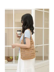 Detail shot of a handmade woven hollow-out shoulder bag in a stylish cafe setting