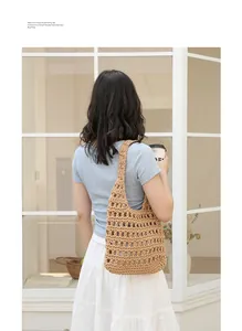 Hand-woven hollow cotton shoulder bag worn by model in a casual lifestyle setting