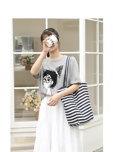 Japanese style casual striped canvas tote bag shown with a model in a lifestyle setting.