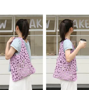 Detail view of purple floral cutout lace shoulder bag with hollow design