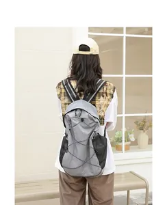 Mochila informal de nailon gris con bolsillos de malla y cordón elástico en modelo