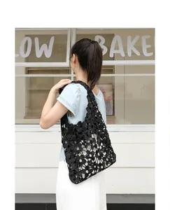 Elegant black floral lace hollow-out shoulder bag on a model for a chic summer look