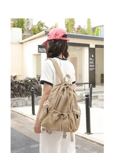 Detail of khaki nylon drawstring backpack with checkered texture and side zippers