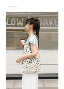 Elegant floral lace crochet underarm bag carried by a model in a stylish street scene
