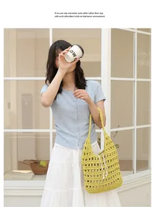 Lifestyle view of a yellow hand-woven cotton thread shoulder bag with a hollow-out design.