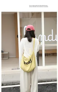 Back view of yellow striped canvas tote bag with 'Read' print carried by a model.