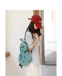 Side view of a girl wearing a light blue grid nylon backpack with drawstring details