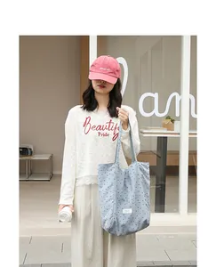 Casual blue polka dot nylon tote bag for women shown in a stylish outdoor lifestyle setting