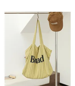 Macro view of striped cotton linen canvas tote bag with Bread letter print detail