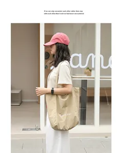 Minimalist Japanese style nylon tote bag shown on a model for daily casual wear.
