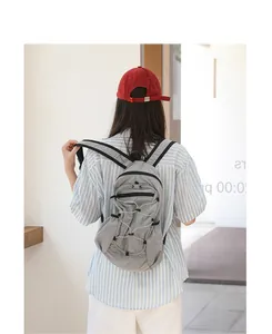 Casual Japanese style grid nylon backpack with drawstring detail on female model back view
