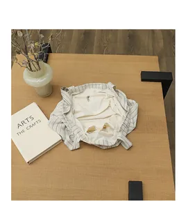 Detailed overhead view of the interior pockets in a stylish striped canvas tote bag