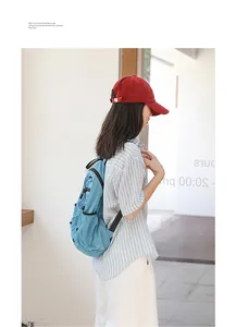 Blue checkered nylon backpack worn by a model in a minimalist lifestyle setting