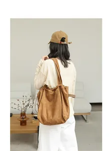 Detail view of a minimalist brown suede drawstring tote bag for casual daily use