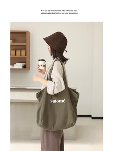 Close-up of a model carrying a green linen tote bag with Salomé print in a minimalist cafe