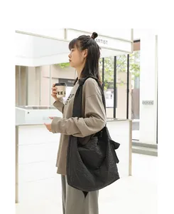 Detailed side view of Japanese style checkered canvas crossbody bag with knot strap