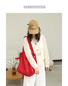 Red suede drawstring tote bag styled on a model in a minimalist lifestyle indoor setting