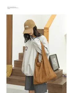 Stylish brown suede drawstring shoulder bag with a slouchy design for casual wear