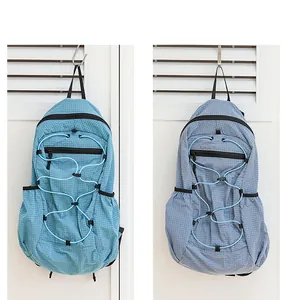 Detail shot of two Japanese style grid nylon backpacks in teal and light blue colors.