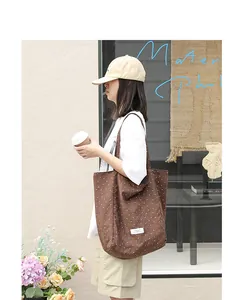 Casual brown nylon tote bag with white polka dots and comfortable shoulder straps