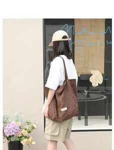 Brown nylon tote bag with white polka dots carried by a model in a casual street setting