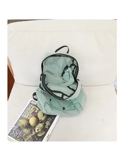 Detailed macro view of an open green plaid nylon casual backpack with drawstring