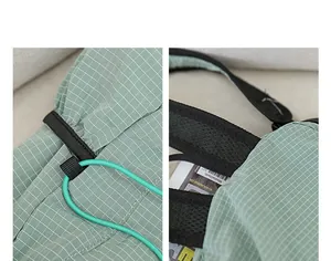 Macro view of light green checkered nylon fabric and drawstring detail on backpack.